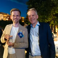 Frederik Madsen and Steen D. Madsen at the M-Files partner awards, holding the Solution Partner of the Year 2025 trophy